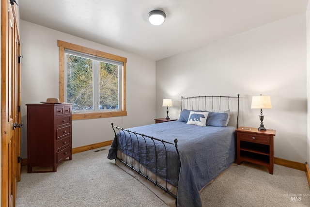 bedroom with visible vents, baseboards, and light colored carpet