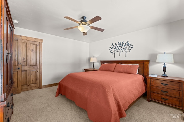 bedroom with light carpet, a ceiling fan, and baseboards