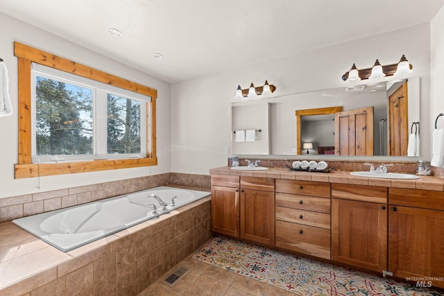 full bathroom featuring double vanity, a garden tub, a sink, and tile patterned floors