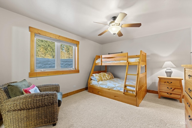 carpeted bedroom featuring baseboards and a ceiling fan