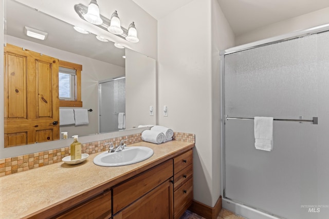 bathroom featuring a stall shower, backsplash, and vanity