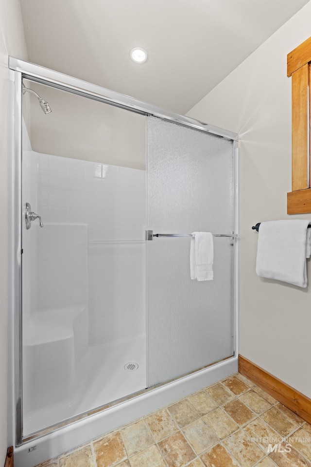 full bathroom featuring recessed lighting, a shower stall, and baseboards