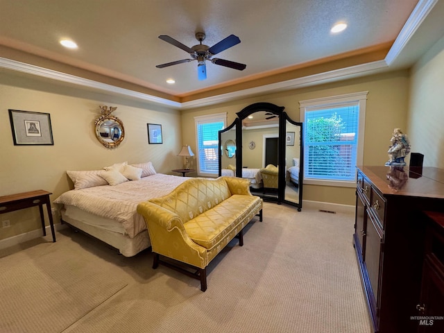 bedroom featuring recessed lighting, a tray ceiling, light carpet, and baseboards