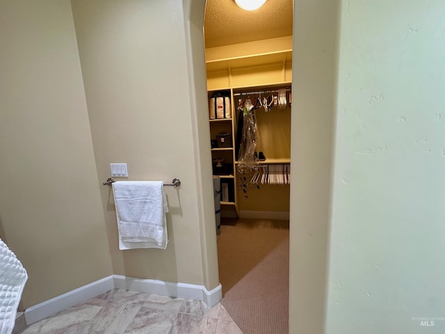 spacious closet with arched walkways