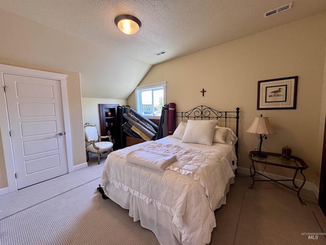 bedroom with carpet floors, baseboards, vaulted ceiling, and visible vents