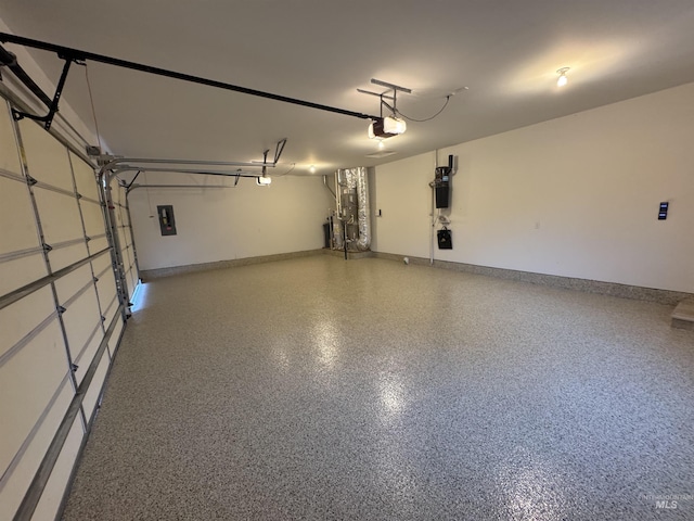 garage with baseboards, a garage door opener, and electric panel