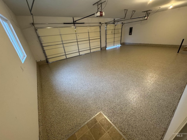 garage with a garage door opener and electric panel