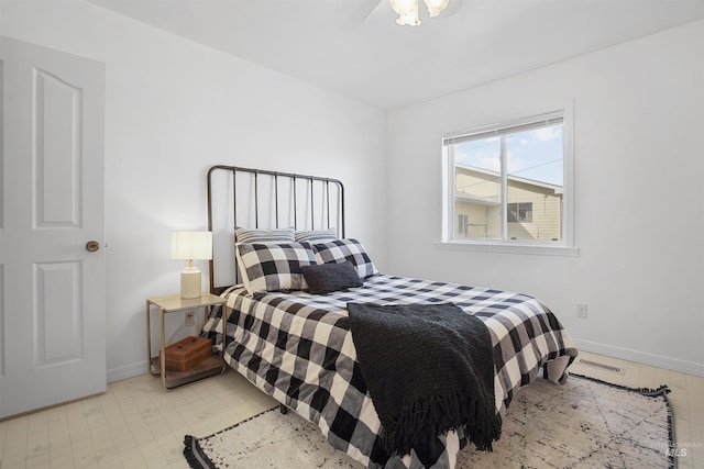 bedroom with baseboards and visible vents