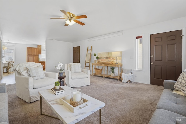 carpeted living area with ceiling fan