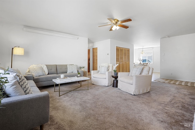 carpeted living room with ceiling fan