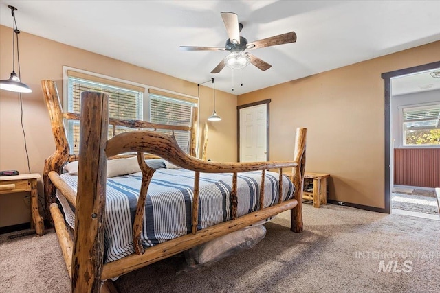 bedroom with light colored carpet, ceiling fan, and baseboards