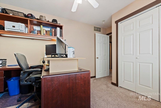 office featuring baseboards, visible vents, carpet, and ceiling fan