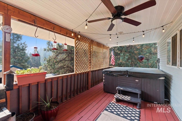 wooden terrace with a hot tub and ceiling fan