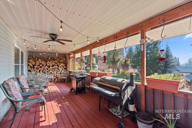 wooden terrace featuring ceiling fan and a grill