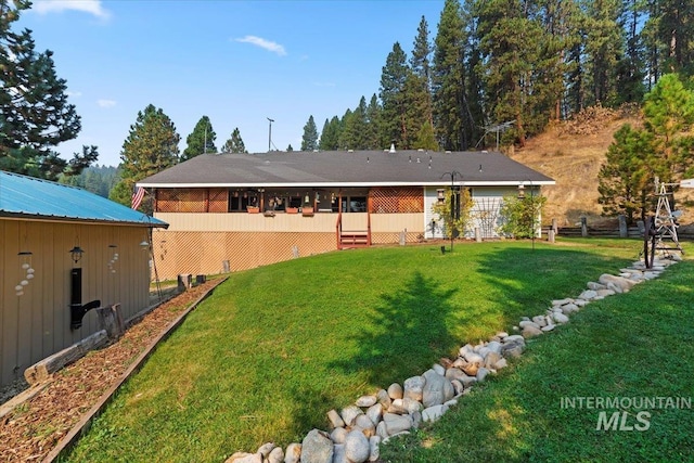 rear view of house with a yard