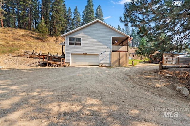view of property exterior featuring a garage and driveway