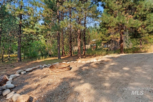 view of yard with a fire pit