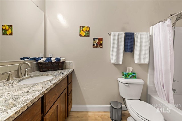 bathroom featuring toilet, vanity, shower / bathtub combination with curtain, wood finished floors, and baseboards