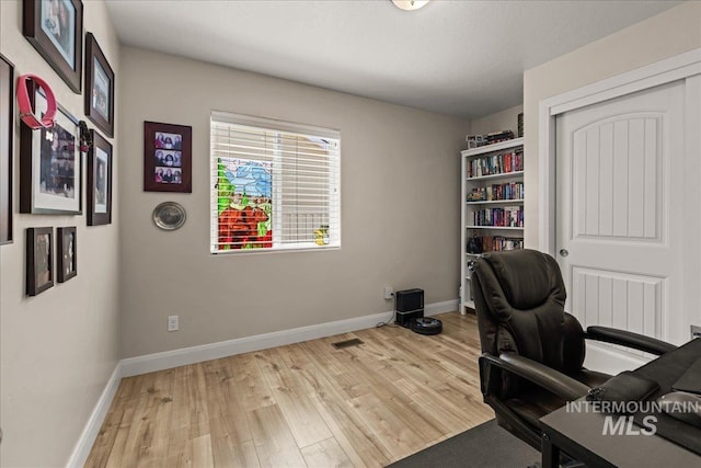 home office featuring wood finished floors and baseboards