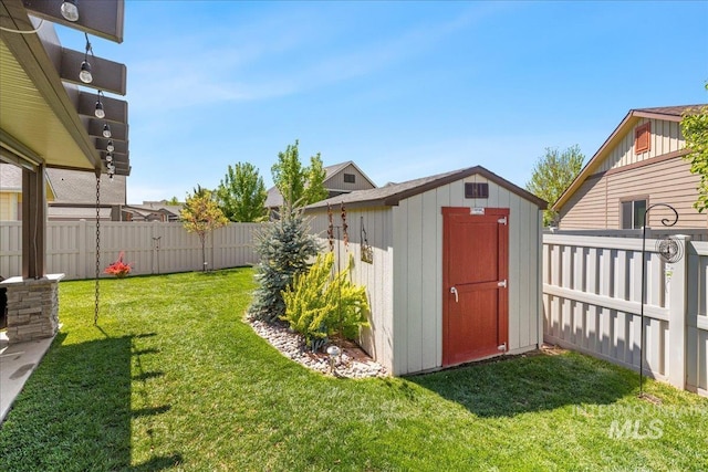 view of yard with a storage unit and an outbuilding