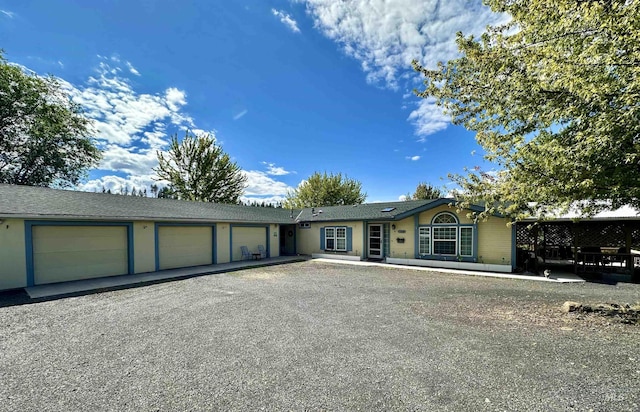 single story home featuring aphalt driveway and an attached garage