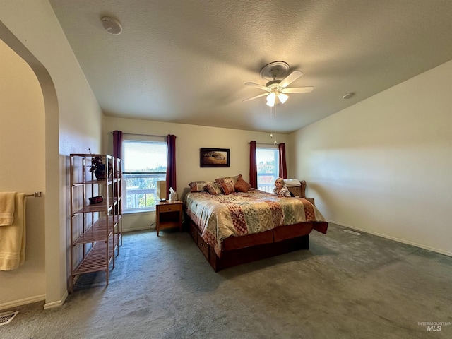 bedroom featuring arched walkways, ceiling fan, carpet flooring, baseboards, and visible vents