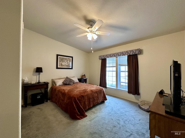 carpeted bedroom featuring ceiling fan and baseboards