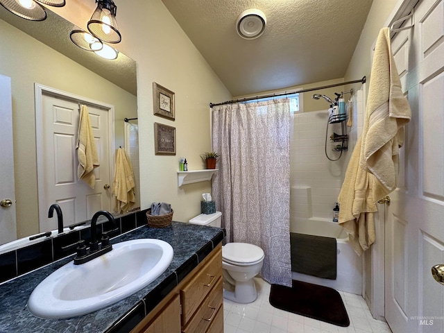 full bath featuring vanity, tile patterned floors, toilet, vaulted ceiling, and a textured ceiling