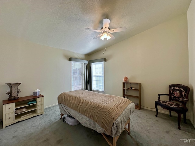 bedroom with a textured ceiling, ceiling fan, vaulted ceiling, and carpet floors