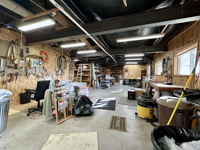 misc room featuring a workshop area and unfinished concrete flooring