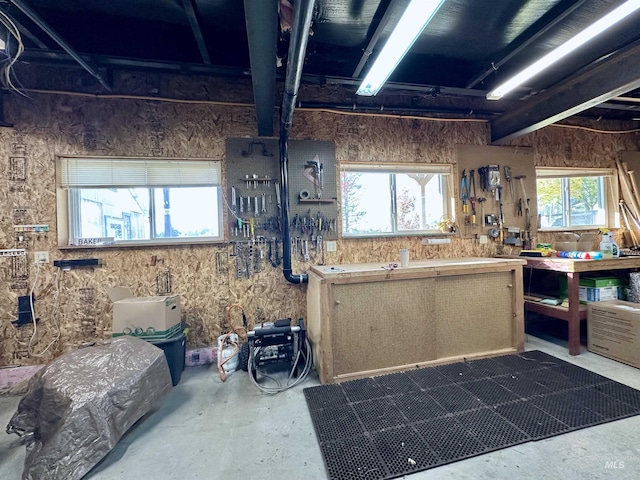 kitchen featuring a healthy amount of sunlight and unfinished concrete floors
