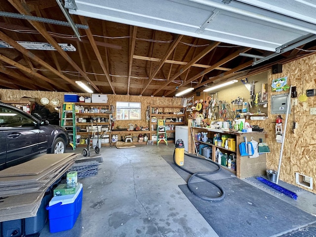garage with a workshop area and visible vents