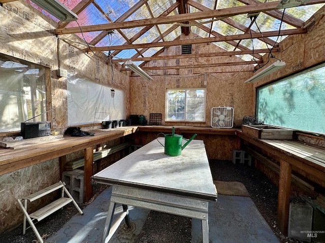misc room featuring a workshop area and high vaulted ceiling