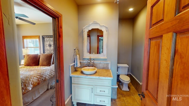 bathroom featuring tile patterned floors, vanity, and toilet