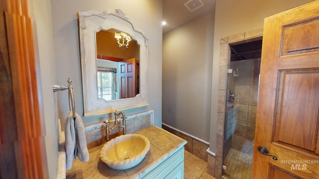 bathroom featuring an enclosed shower, vanity, and tile patterned flooring