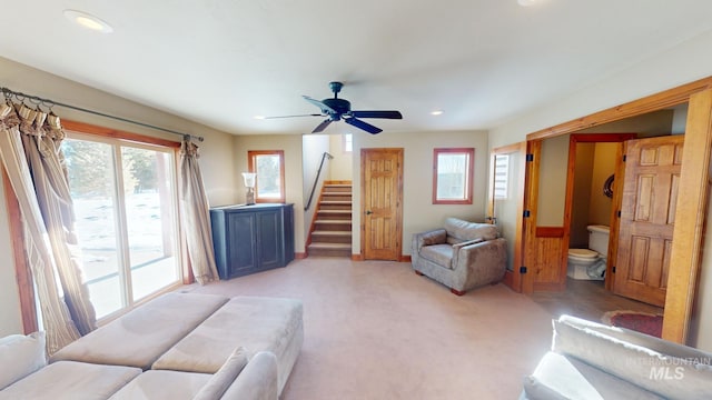 carpeted living room featuring ceiling fan