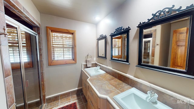 bathroom featuring vanity and a shower with shower door