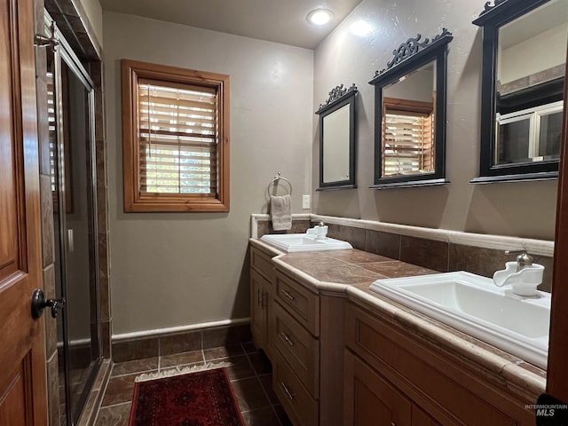 bathroom with vanity, a shower with shower door, and tile patterned floors