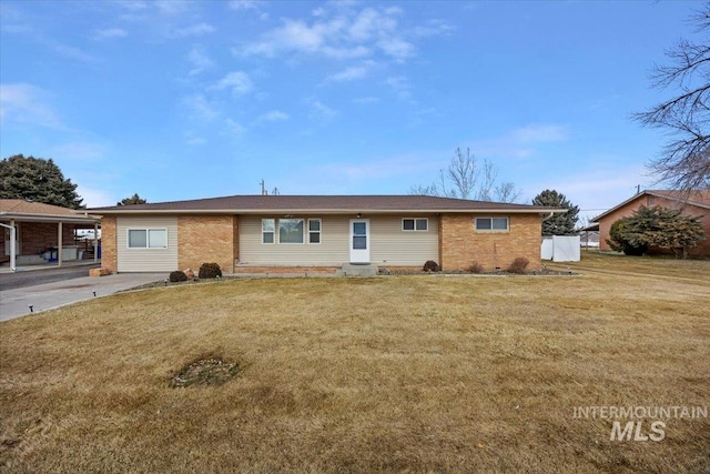 ranch-style house with brick siding and a front lawn