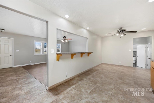 spare room with recessed lighting, visible vents, ceiling fan, a textured ceiling, and baseboards