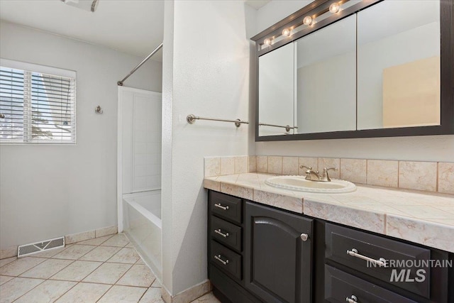 bathroom with visible vents, baseboards,  shower combination, tile patterned flooring, and vanity