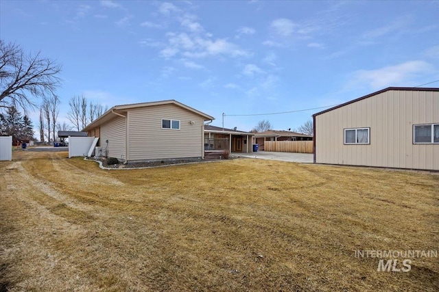 rear view of property featuring a lawn