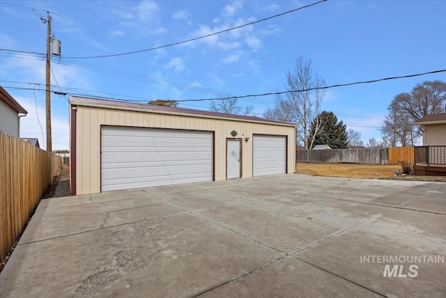 detached garage featuring fence