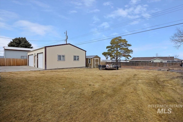 view of yard with an outdoor structure and fence