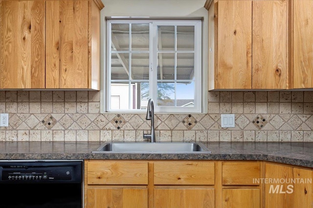 kitchen with black dishwasher, tasteful backsplash, and a sink