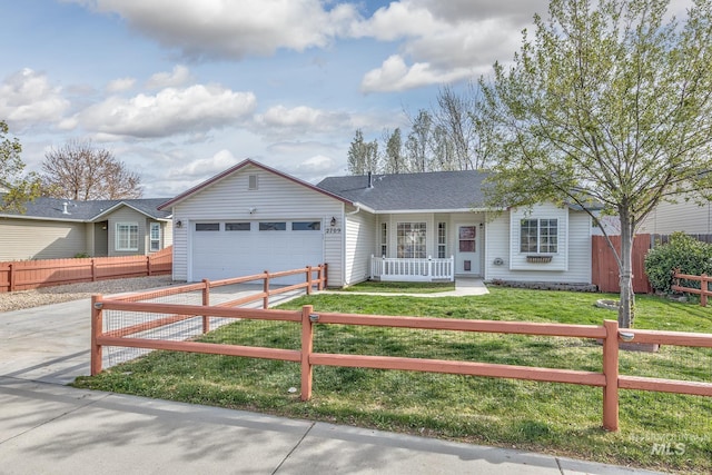 ranch-style home with a shingled roof, a garage, a fenced front yard, a front lawn, and driveway