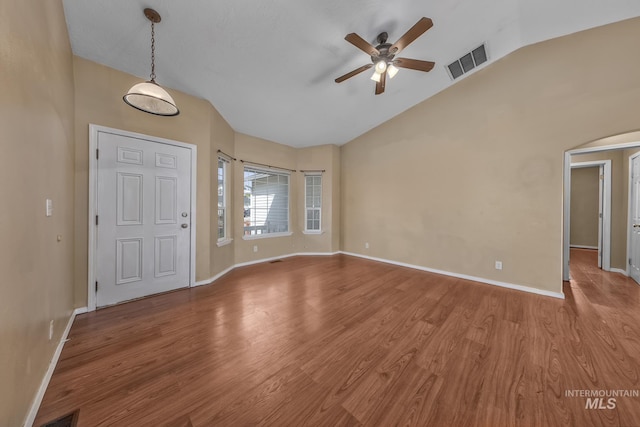 entryway featuring baseboards, lofted ceiling, a ceiling fan, and visible vents