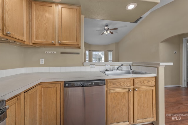 kitchen with light countertops, a ceiling fan, stainless steel dishwasher, arched walkways, and a sink