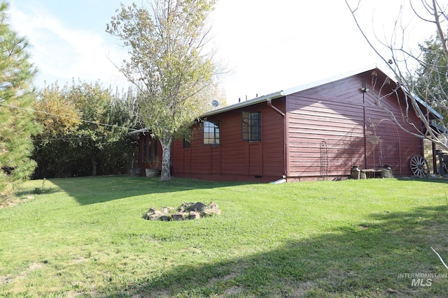 view of side of property with a lawn