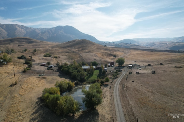 view of mountain backdrop with rural landscape